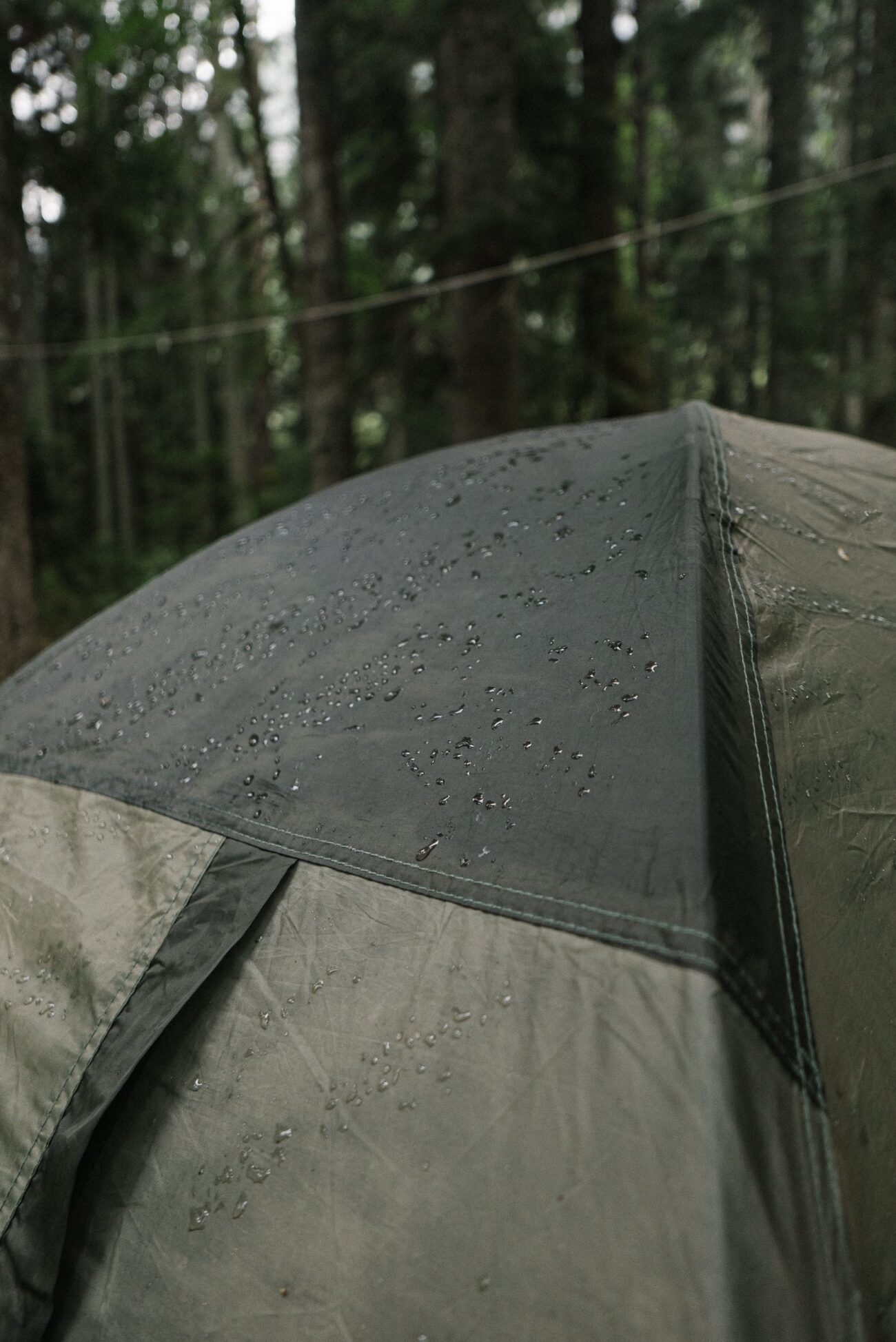 Close-up of a wet tent fabric showing water beading on the surface